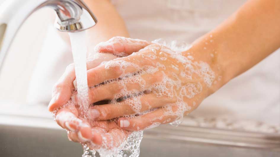 fair skinned person washing their hands